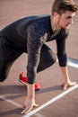 Athlete on starting position at running track. Runner practicing run in stadium racetrack Royalty Free Stock Photo