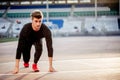 Athlete on starting position at running track. Runner practicing run in stadium racetrack Royalty Free Stock Photo