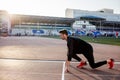 Athlete on starting position at running track. Runner practicing run in stadium racetrack Royalty Free Stock Photo