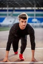 Athlete on starting position at running track. Runner practicing run in stadium racetrack Royalty Free Stock Photo