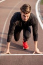 Athlete on starting position at running track. Runner practicing run in stadium racetrack Royalty Free Stock Photo