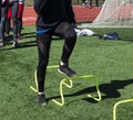 Athlete stepping over yellow mini hurdles Royalty Free Stock Photo