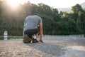 An athlete, strong Asian male runner is getting ready to run, exercising outdoors in the morning