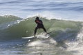 Athlete surfing on Santa Cruz beach in California