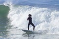 Athlete surfing on Santa Cruz beach in California