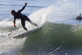 Athlete surfing on Santa Cruz beach in California