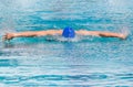 Athlete swimmer swimming butterfly strokes in pool Royalty Free Stock Photo