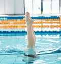 Athlete, swimming and legs in water upside down, exercise and training for healthy body wellness. Pool, feet and person