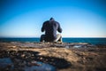 Athlete taking break sitting on rocks