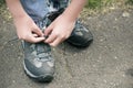 The athlete ties the laces on his sneakers.