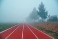 Athlete Track or Running Track in autumn nature. Blue misty background. White edit space Royalty Free Stock Photo