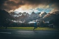 Athlete training in alps Village. Big Mountains and orange morning sky in background Royalty Free Stock Photo