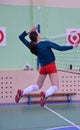 The athlete trains a spike on a volleyball net