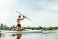 Athlete trains on a sup board, swims on the river and paddles. Surfing on the sup board as a hobby