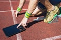 Athlete Using Tablet on the Track Royalty Free Stock Photo