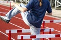 Athlete walking over hurdles to warm up before a race Royalty Free Stock Photo