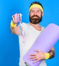 Athlete wear bandages for sweat. Man bearded athlete hold fitness mat and tape measure. Athlete guide stay in shape. Old