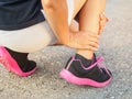 Athlete woman has ankle injury, sprained leg during running training. sport concept. Royalty Free Stock Photo