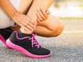 Athlete woman has ankle injury, sprained leg during running training. sport concept.