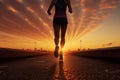 Athlete woman runner training run on the road. Morning jogging for a healthy lifestyle under the sunrise sky. Cardio exercise. Fit