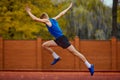 Athlete& x27;s controlled sprint before liftoff. Side view full length portrait of professional sportsman fast running on Royalty Free Stock Photo