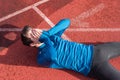 Athlete young man tired, lying on running track. Royalty Free Stock Photo