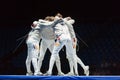 Athletes embrace in competitions on championship of world in fencing