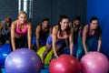 Athletes exercising with fitness ball in gym Royalty Free Stock Photo