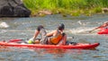 Athletes kayakers during training on whitewater. Man on inflatable stand up paddle board SUP