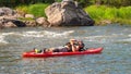 Athletes kayakers during training on whitewater. Man on inflatable stand up paddle board SUP