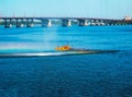 Athletes in kayaks in training near the river fountain in a rainbow of splashes Royalty Free Stock Photo