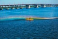 Athletes in kayaks in training near the river fountain in a rainbow of splashes