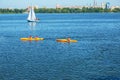 Athletes in kayaks in training near the river fountain in a rainbow of splashes Royalty Free Stock Photo