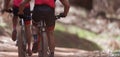 Athletes mountain biking on forest trail