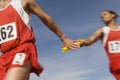 Athletes Passing Baton In Relay Race Royalty Free Stock Photo