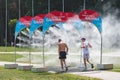 Athletes running through water mist to cool down during a competition