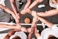 Athletes showing trust and standing united. Men expressing team spirit with their hands joined huddling at a basketball