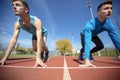 Athletes at the sprint start line in track and field Royalty Free Stock Photo