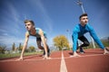 Athletes at the sprint start line in track and field Royalty Free Stock Photo