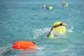 Athletes swimming free style in the sea during triathlon competition. Swimmer in the ocean