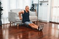 Athletic and active senior man using furniture for pushup. Clout