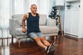 Athletic and active senior man using furniture for pushup. Clout