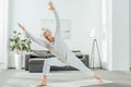 athletic adult man practicing yoga on mat