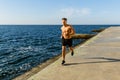 athletic adult shirtless man jogging