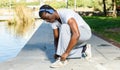 Athletic african american male in headphones before running in park Royalty Free Stock Photo