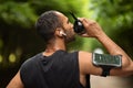 Athletic african american man drinking water, exercising at park Royalty Free Stock Photo