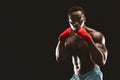 Athletic african fighter demonstrating classical boxing stance