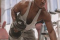 Athletic African man working out with dumbbells at the gym Royalty Free Stock Photo