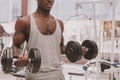 Athletic African man working out with dumbbells at the gym Royalty Free Stock Photo