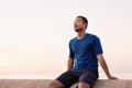 Athletic Asian man taking a breather during a morning run Royalty Free Stock Photo